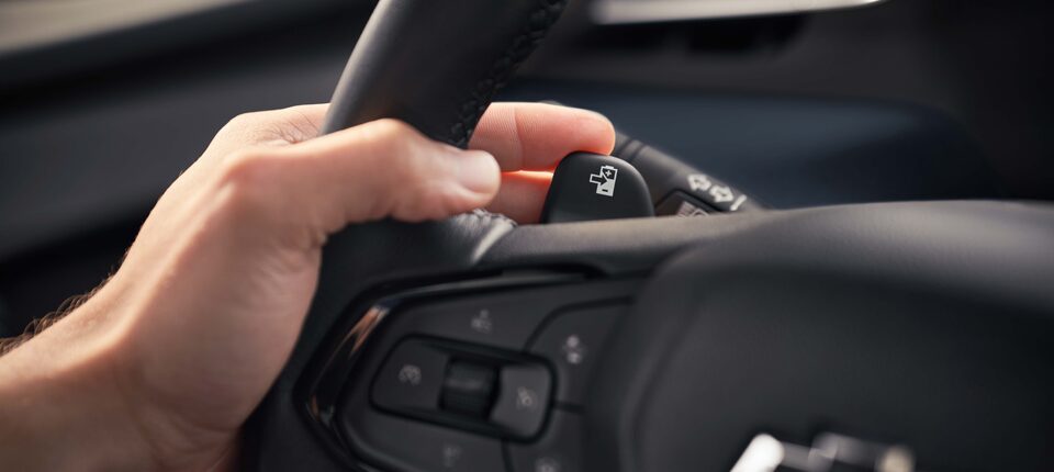 Driver's Hand on Regen on Demand Button of 2023 Bolt EUV 