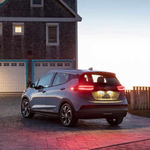 Rear 3/4 Image of 2023 Bolt EV Parked outside Home at Sunset