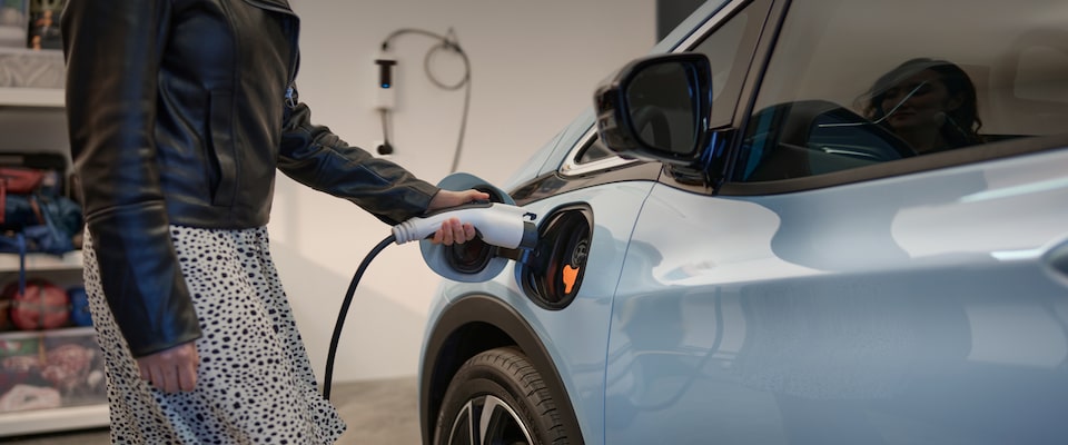 Close up of Woman Plugging in 2023 Bolt EV to Charge