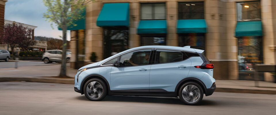 Drivers Side Profile Shot of Silver 2023 Bolt EV Parked on City Street