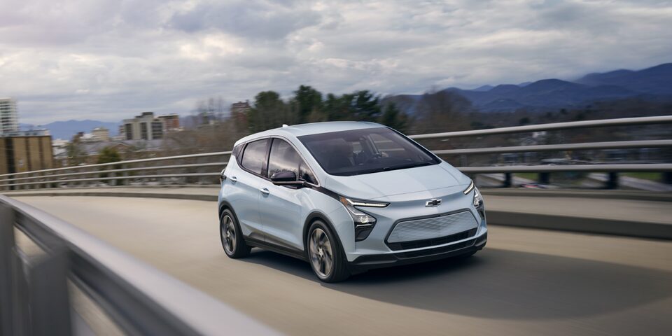 Front 3/4 Image of Silver 2023 Bolt EV Driving on Overpass