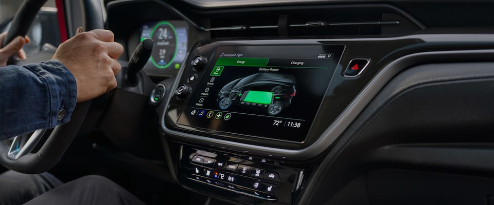 2023 Bolt EV Driver's Hands on Wheel Next to Color Touch-Screen Showing Battery Power