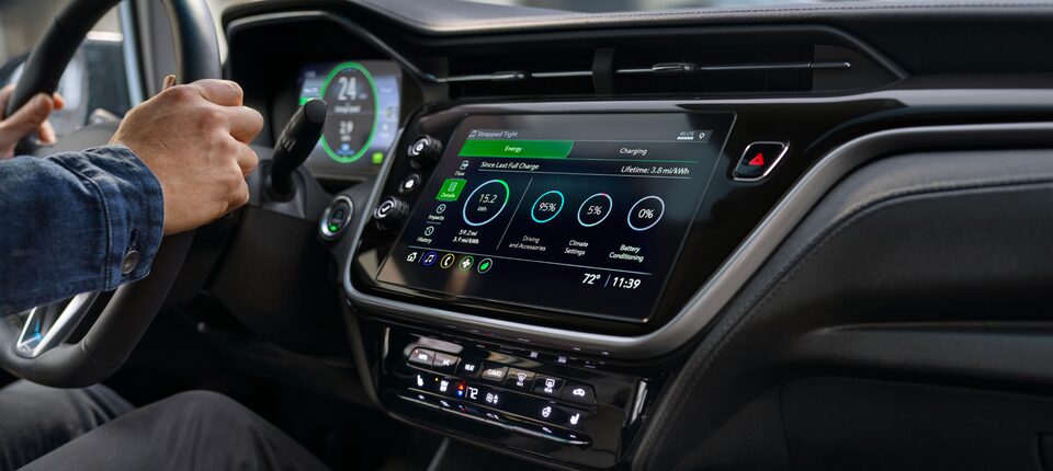 2023 Bolt EV Driver's Hands on Wheel Next to Color Touch-Screen Showing Energy Statistics