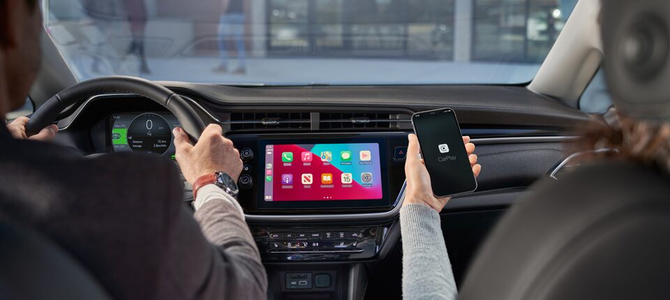 Couple Riding in 2023 Bolt EV Enjoying Apple CarPlay on Chevrolet Infotainment 3 System