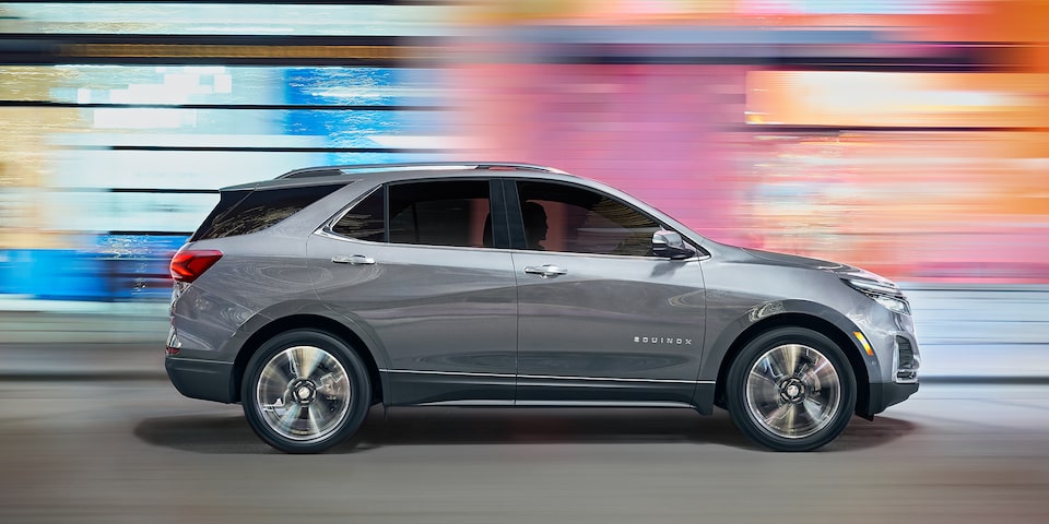 The Iron Grey Metallic 2023 Chevy Equinox Speeding Through the City