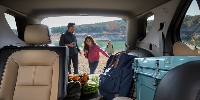 A Young Family Finishes Up Their Camping Trip by Loading Up Their 2023 Chevy Equinox
