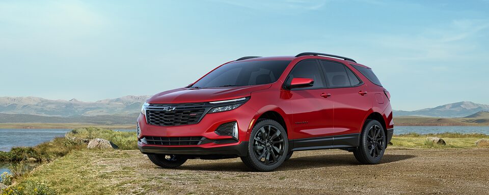 The Cherry Red Tintcoat 2023 Chevy Equinox Parked on an Ocean Cliffside