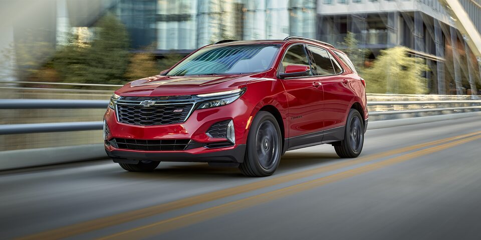 The 2023 Cherry Red Tintcoat Chevy Equinox Cruising Quickly Through the City-Center