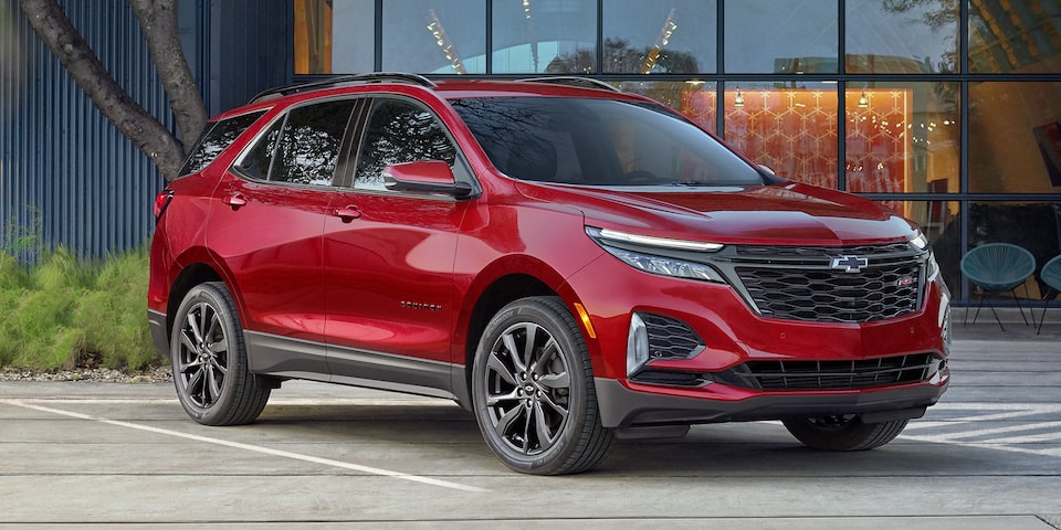 The 2023 Cherry Red Tintcoat Chevy Equinox Parked in the City