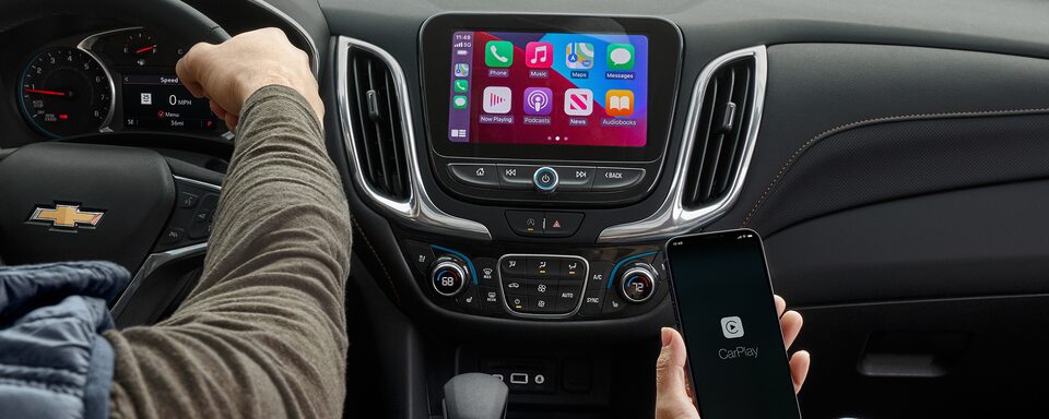 A Couple Uses the Apple Car Play Feature to Enhance their 2023 Chevy Equinox Experience