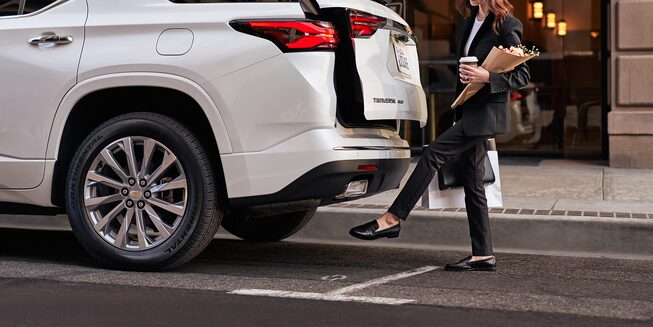 Woman Waving Foot Under Chevy Hands-Free Power Liftgate
