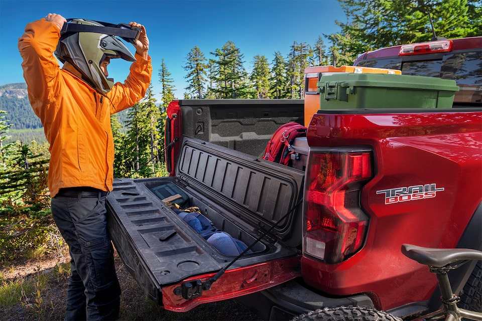 A Man Unloads Gear from His Colorado's Stow Gate