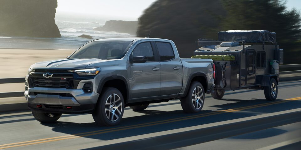 The Colorado Towing a Small Trailer on an Empty Coastal Road