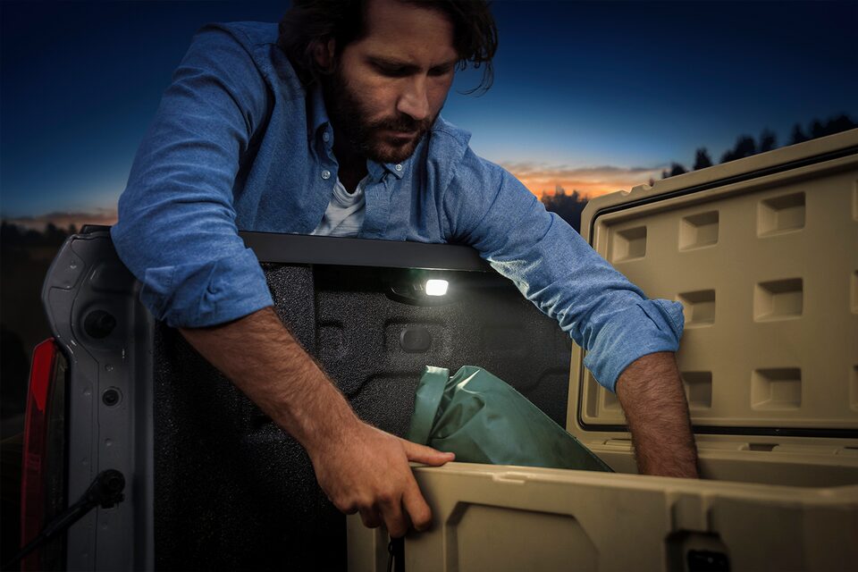 A Man Grabbing Tools from the Truck Bed of His Colorado