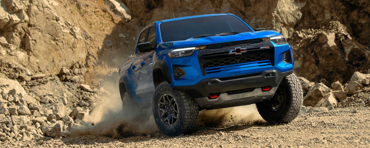 2024 Blue Chevy Colorado ZR2 driving off road on extreme rocky terrain