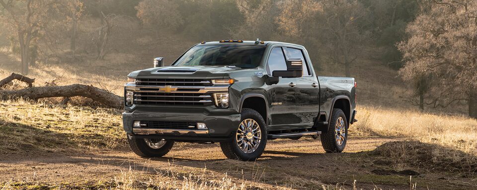 Northsky Blue Metallic Chevy Silverado Majestically Parked with a Scenic Mountain Background