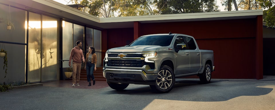 A Couple Prepares to Enter Their 2023 Silver Ice Metallic Chevy Silverado