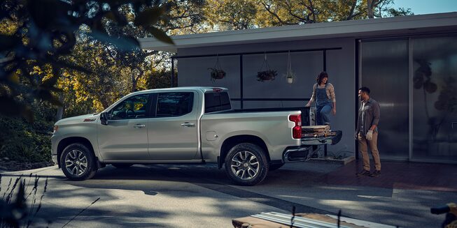 Couple Loading Supplies Into the Back of a Chevrolet Silverado 1500