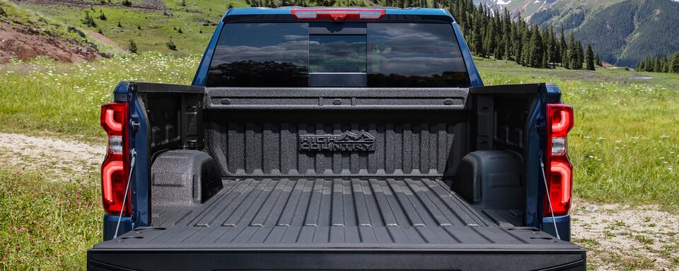 The Durabed of the Silverado High Country With a Forest Backdrop