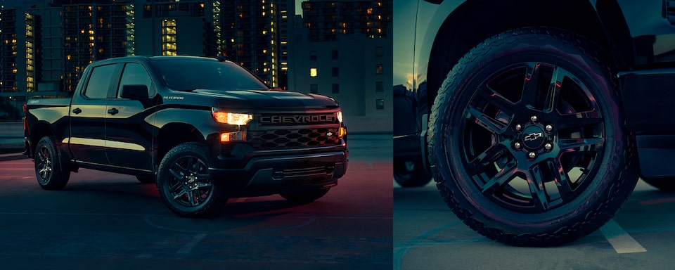 The Black 2023 Silverado Parked in a Lit City Center Along Side Their Sleek Wheel & Rim Design