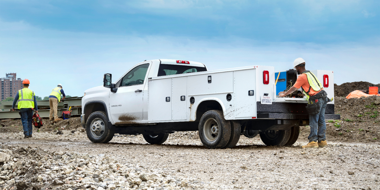 Construction Workers Unloading Equipment from Their 2024 Chevy Silverado 3500 Chassis Cab
