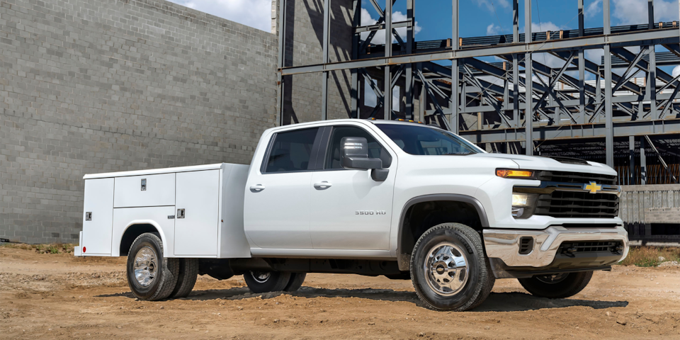 2024 Chevy Silverado 3500 Chassis Cab with a Utility Trailer Parked on a Construction Site