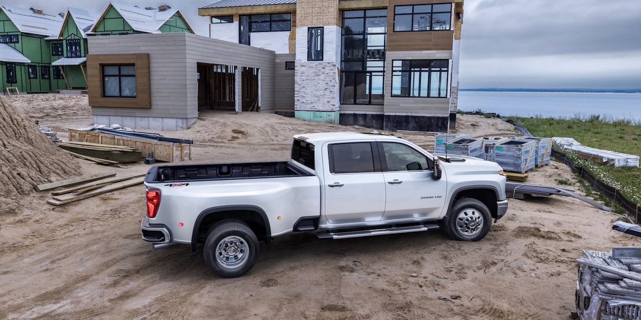 White Silverado HD Parked Outside Home Under Construction