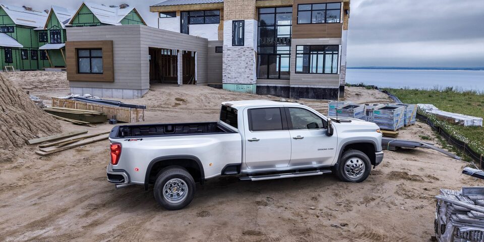 White Silverado HD Parked Outside Home Under Construction