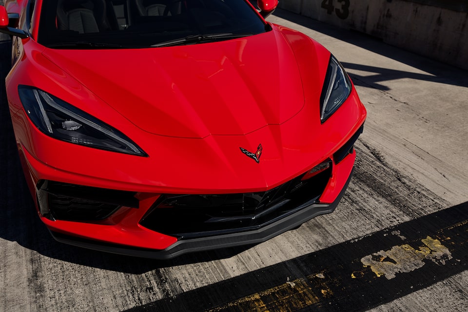 A Torch Red 2024 Chevy Corvette Lined Up At Starting Line on A Race Track