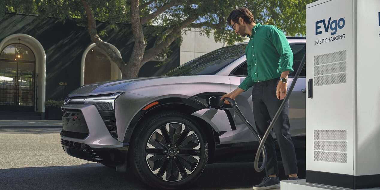 a gray suv being charged at a fast charging station