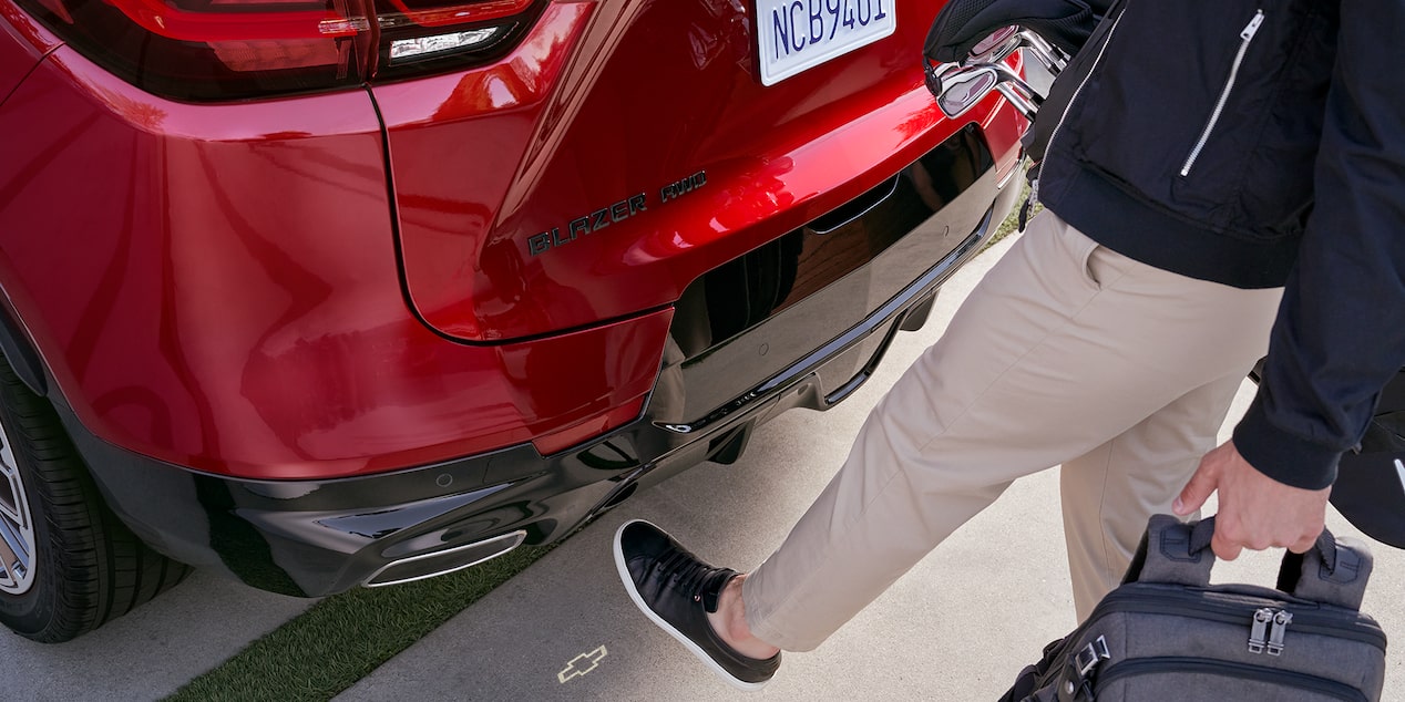Person Using Automatic Lift Tailgate Feature by Putting Their Leg Near the Rear of the Vehicle