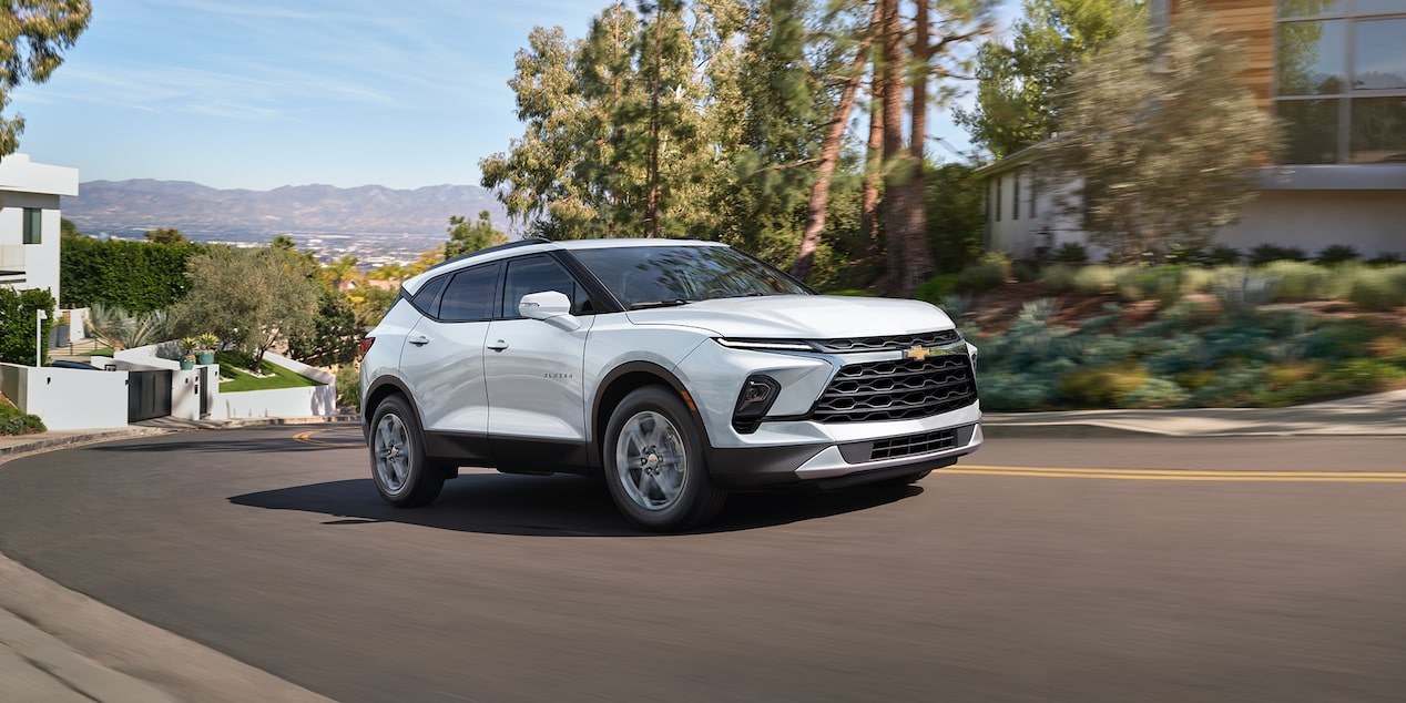 2024 Chevrolet Blazer Driving on a Quiet Street Lined by Trees