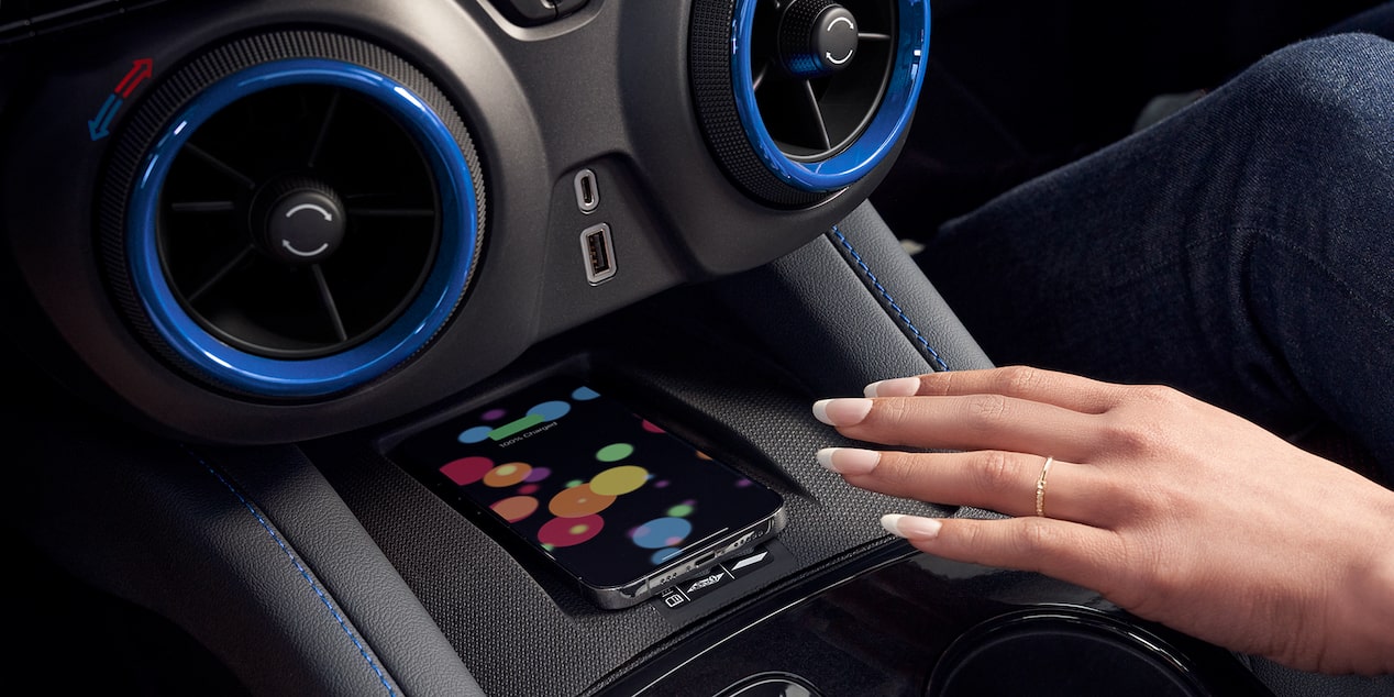 Woman Reaching for Her Smartphone on The Wireless Charger Feature