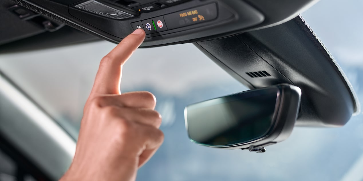 Person Pressing the OnStar Button in Their Chevrolet Vehicle