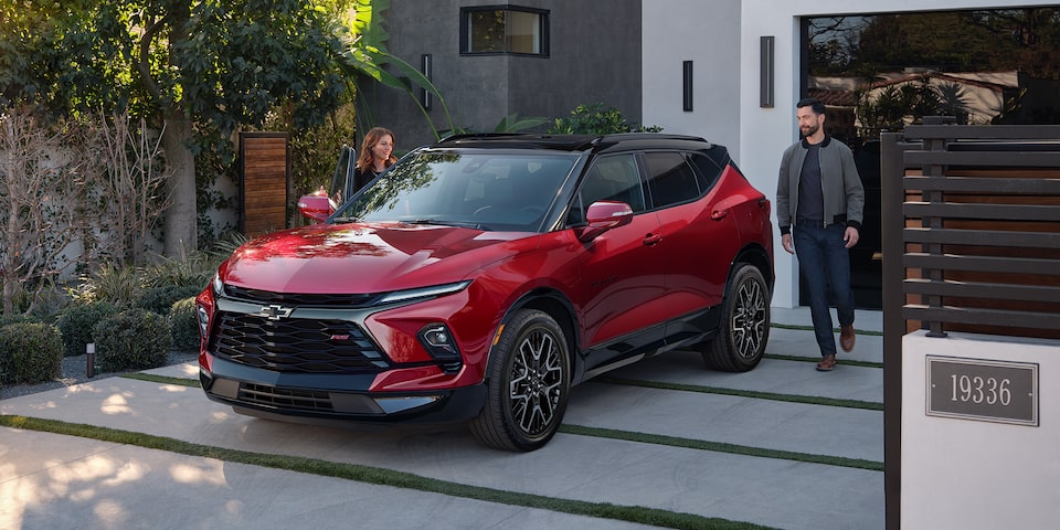 A Man and Woman Walking Towards Their Vehicle