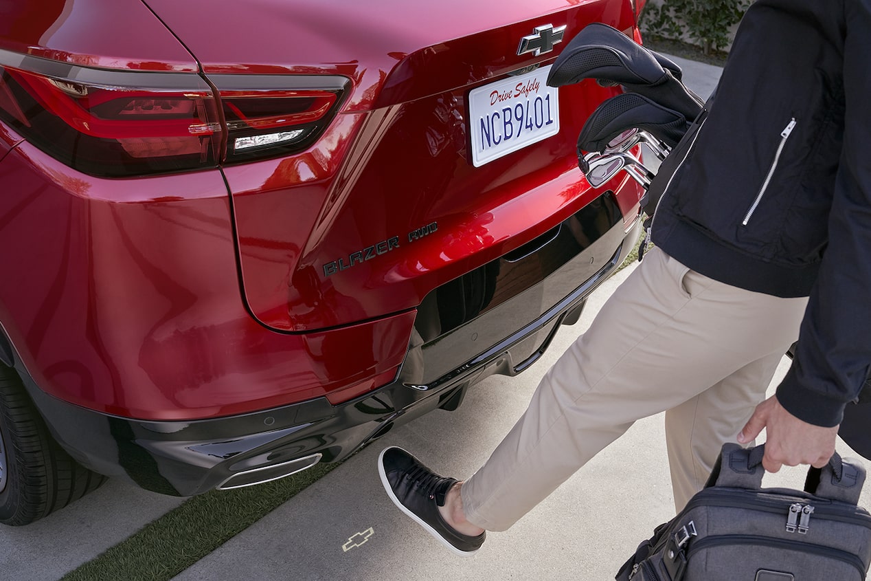 Person Using Automatic Lift Tailgate Feature by Putting Their Leg Near the Rear of the Vehicle