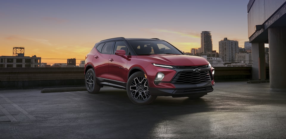2024 Blazer SUV Parked on Top of a Parking Garage with a Sunset in the Background