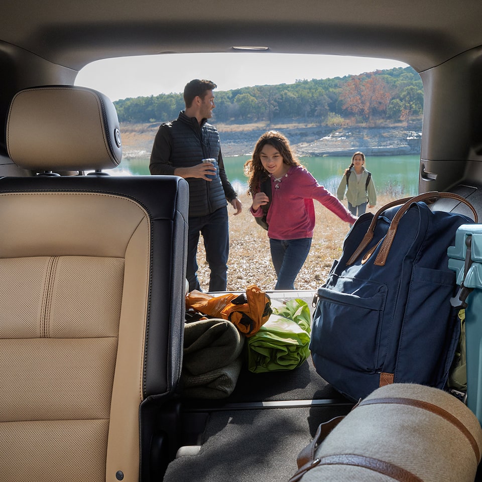 A Family Unpacks Their Camping Gear from Their Equinox