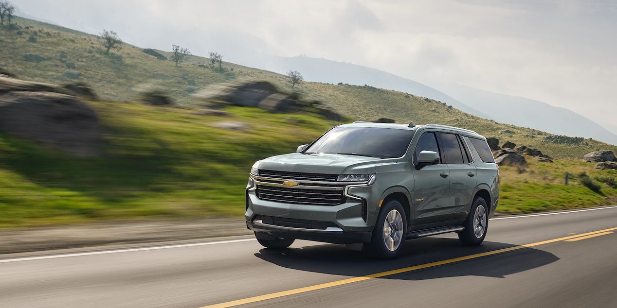 The 2024 Chevy Tahoe Driving Along Side A Hilly Landscape