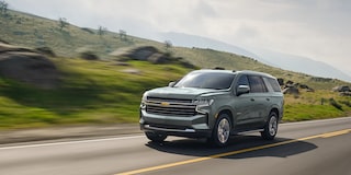 The 2024 Chevy Tahoe Driving Along Side A Hilly Landscape