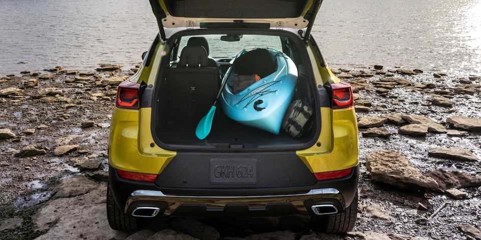 The Trailblazer Parked in Front of the Water with Two Kayaks in the Trunk