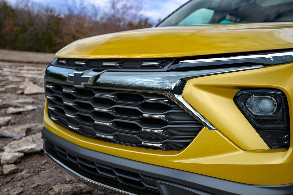 The Redesigned Fascia and Grille of the Trailblazer Parked Along a Woodland Coast