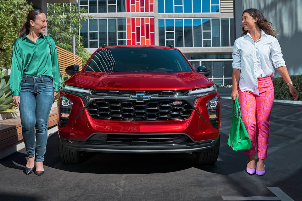 Two Women Walking Away From a 2024 Chevy Trax