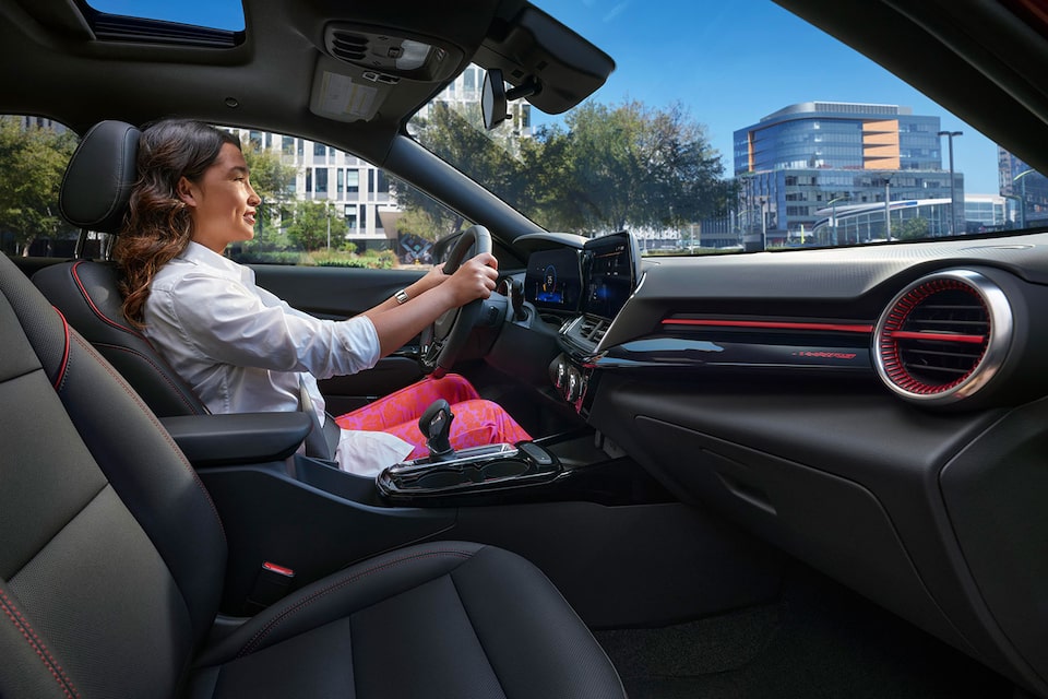 View From Passenger Side of a Woman Driving 2024 Chevy Trax