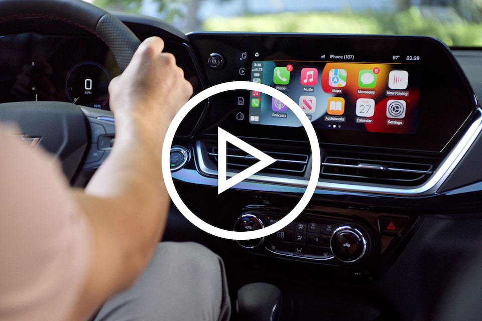 Driver Using Infotainment Screen in  Chevy 2024 Trax