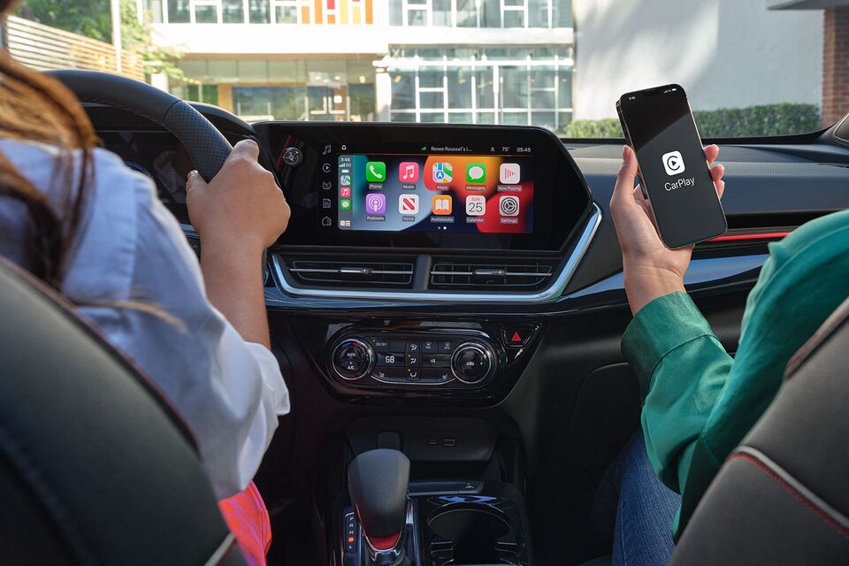 Driver Using Infotainment Screen in Chevy 2024 Trax 