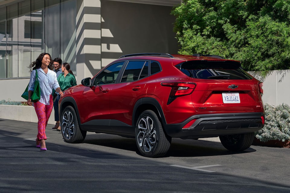 Woman Walking Past Chevy 2024 Trax Through a City