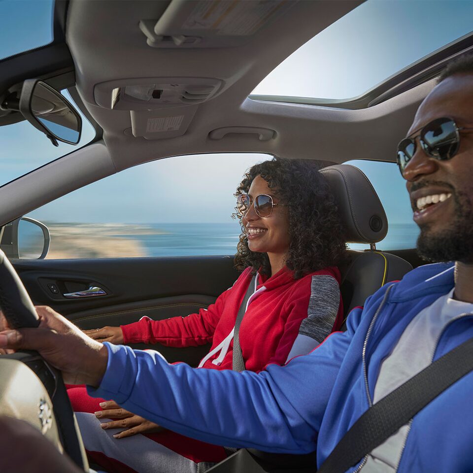 Couple Smiling while Riding in the  Chevy 2024 Trax