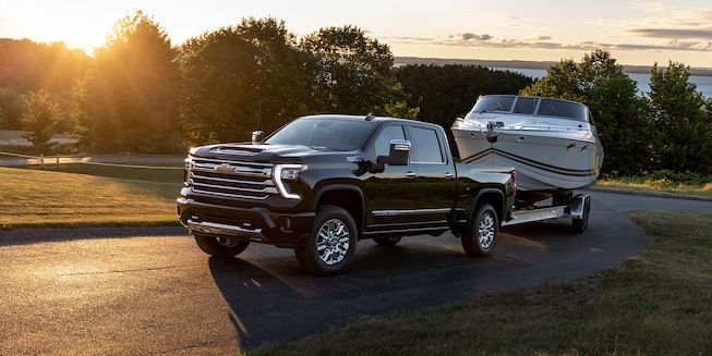 2024 Silverado HD Towing a Boat at Sunset