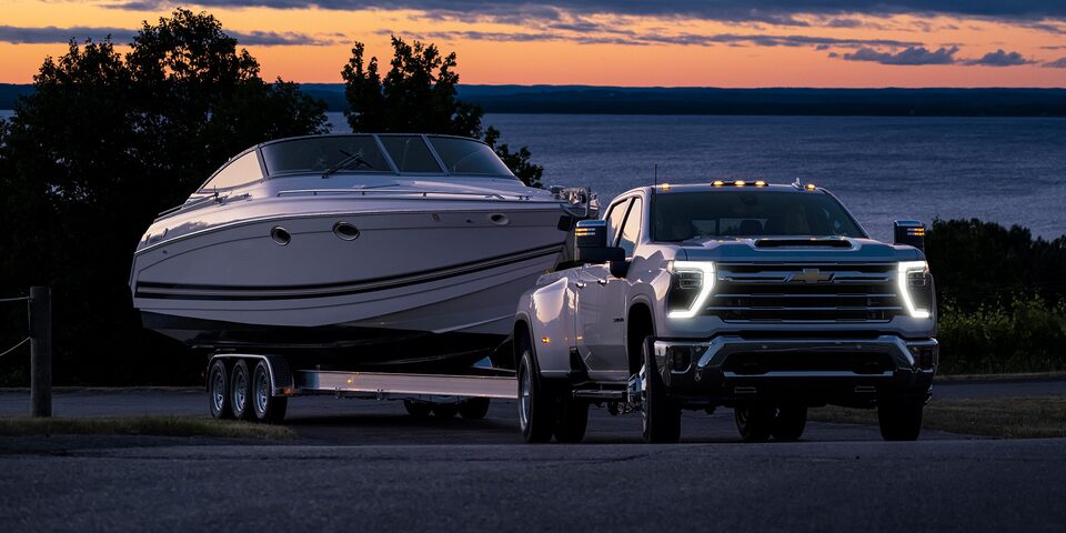 The 2024 Summit White Silverado HD Leaving the Lake while Hauling a Boat